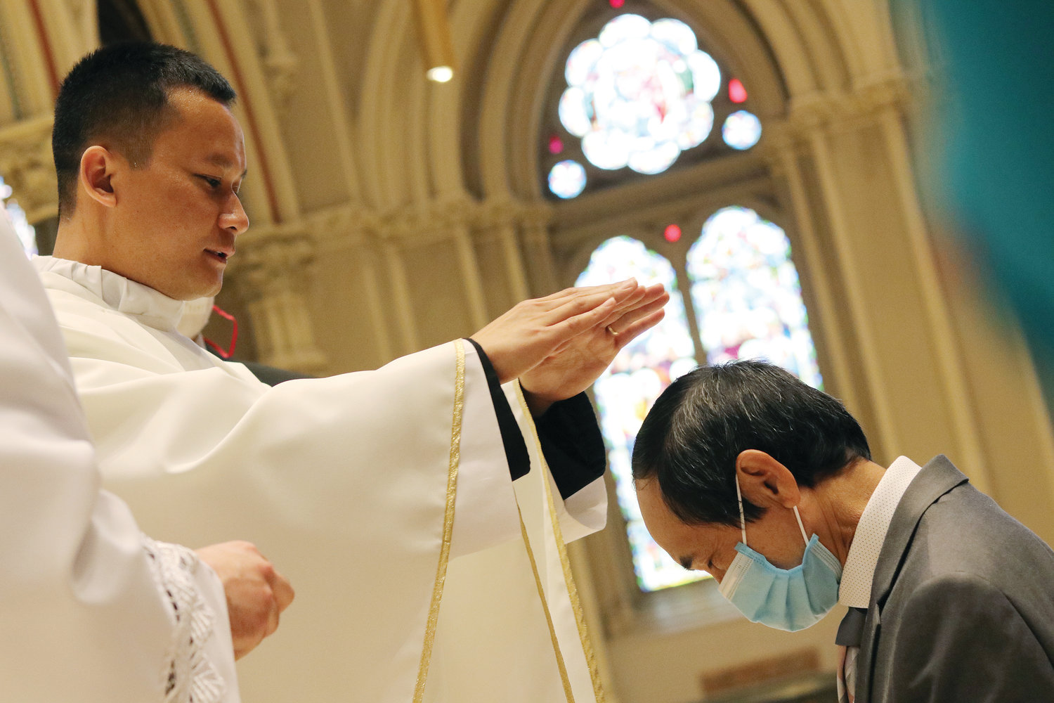 Following the Mass, Father Hiep Van Nguyen confers individual blessings upon those gathered.